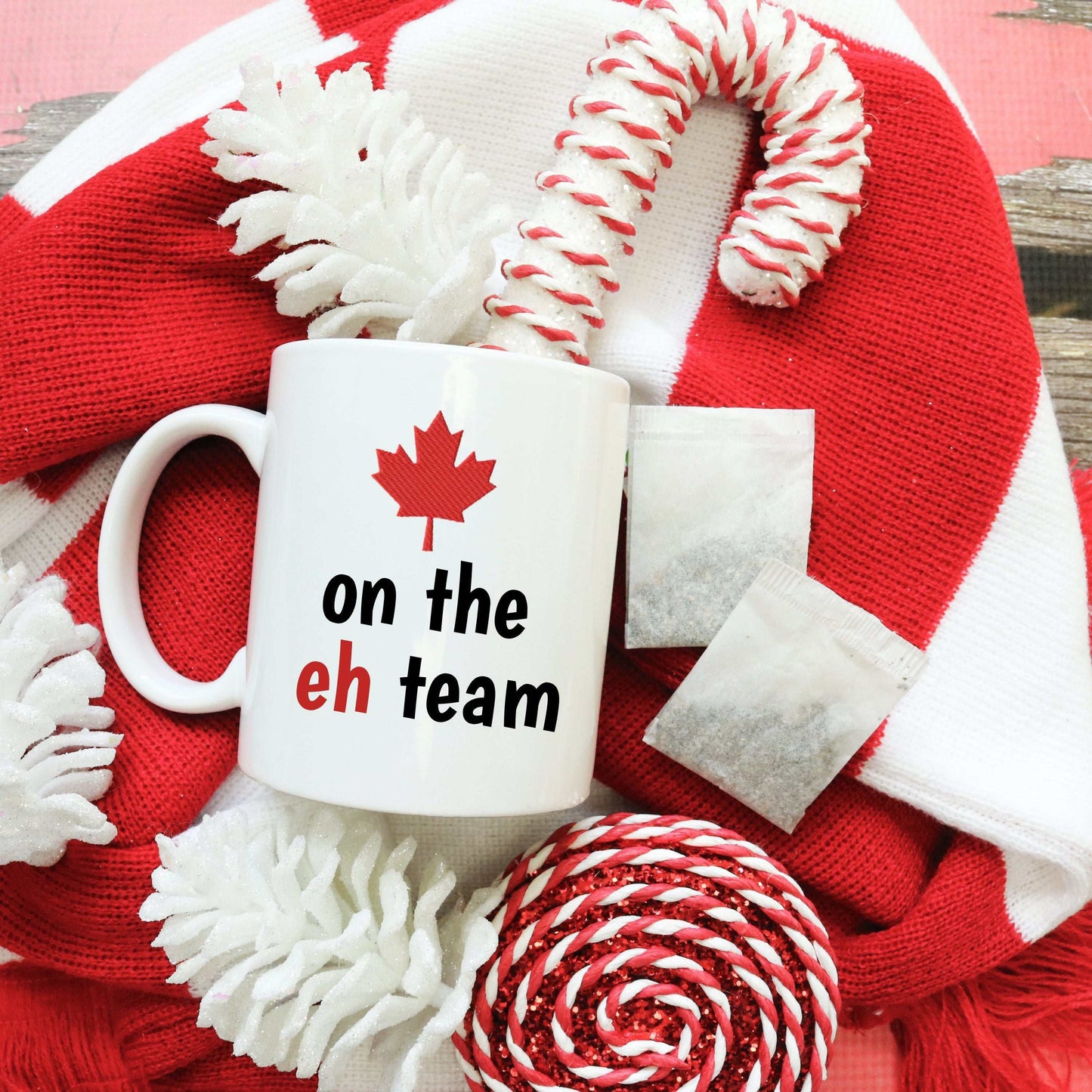 White ceramic mug with red maple leaf and "on the eh team" text, Canadian pride design, 11oz or 15oz size