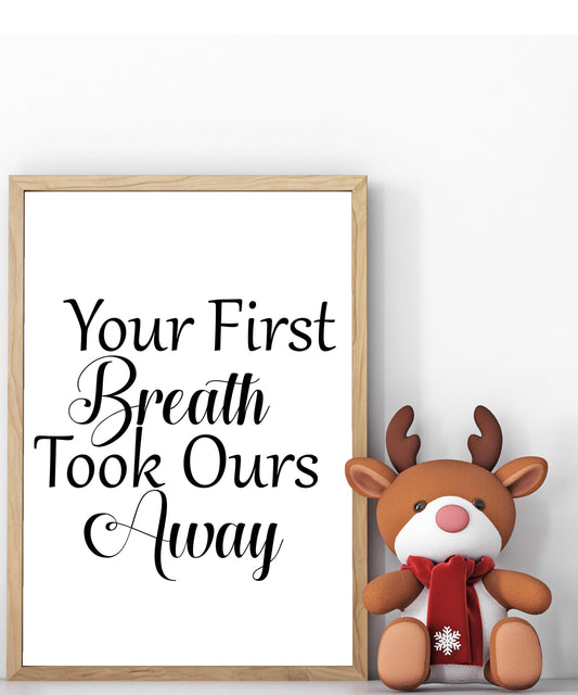 Wood framed sign with the phrase "Your First Breath Took Ours Away" for nursery decor, shown with a plush reindeer toy.