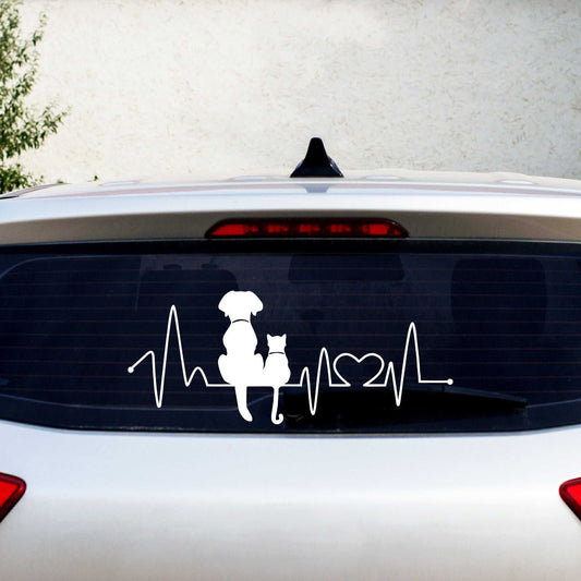 Dog and cat heartbeat car decal on rear window with pets silhouette and heart symbol in white vinyl.