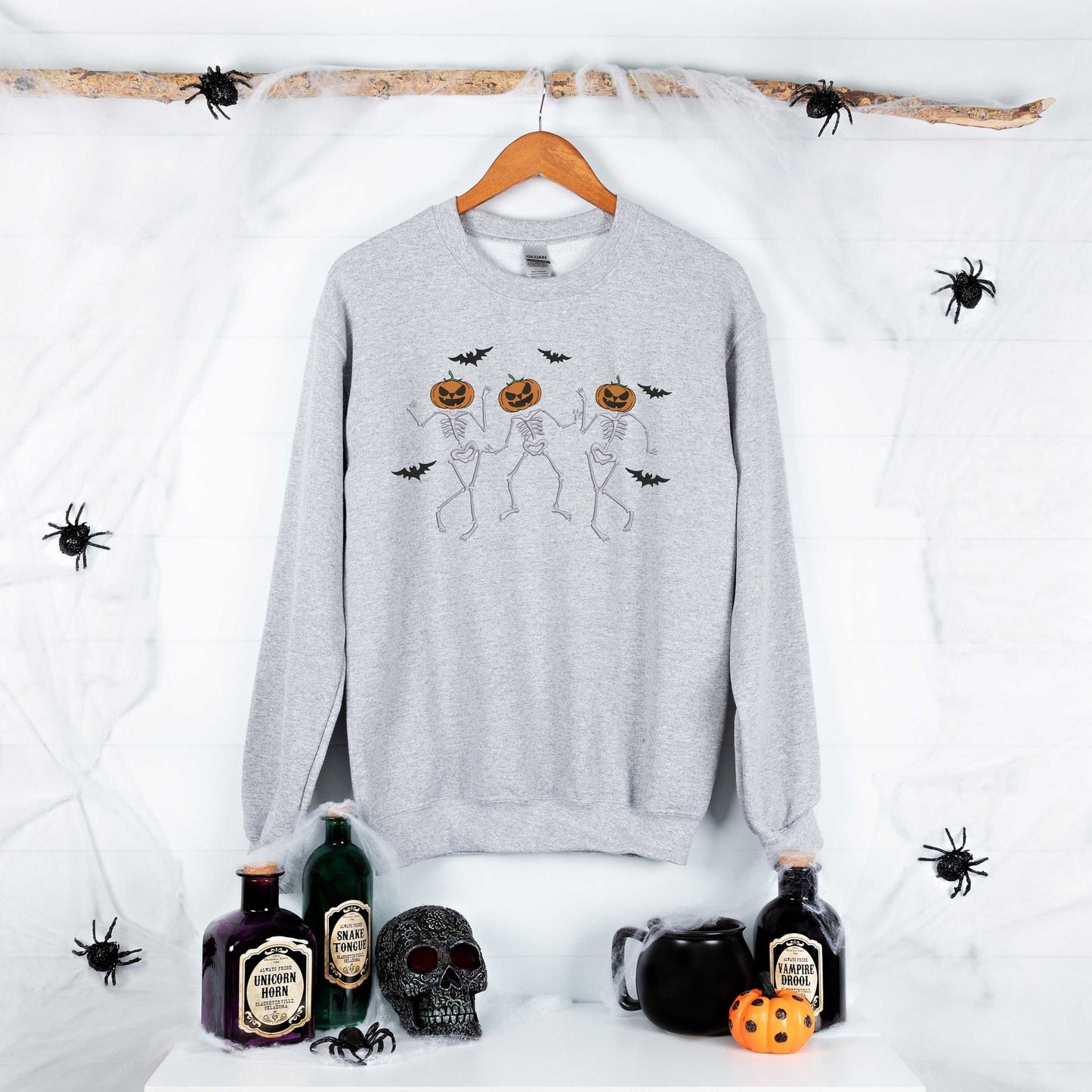 Dancing skeleton pumpkin face sweatshirt with cute Halloween design for women, perfect fall spooky shirt