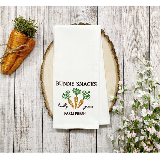 Easter-themed bunny snacks cotton tea towel with carrot embroidery on wooden background.