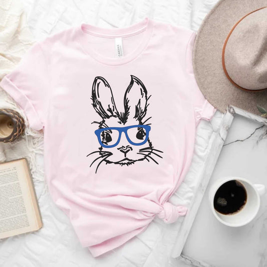 Unisex Easter bunny with glasses graphic tee in pastel pink, perfect for spring celebrations.