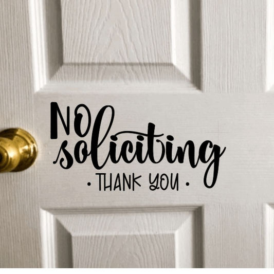 No Soliciting vinyl door decal on white door.