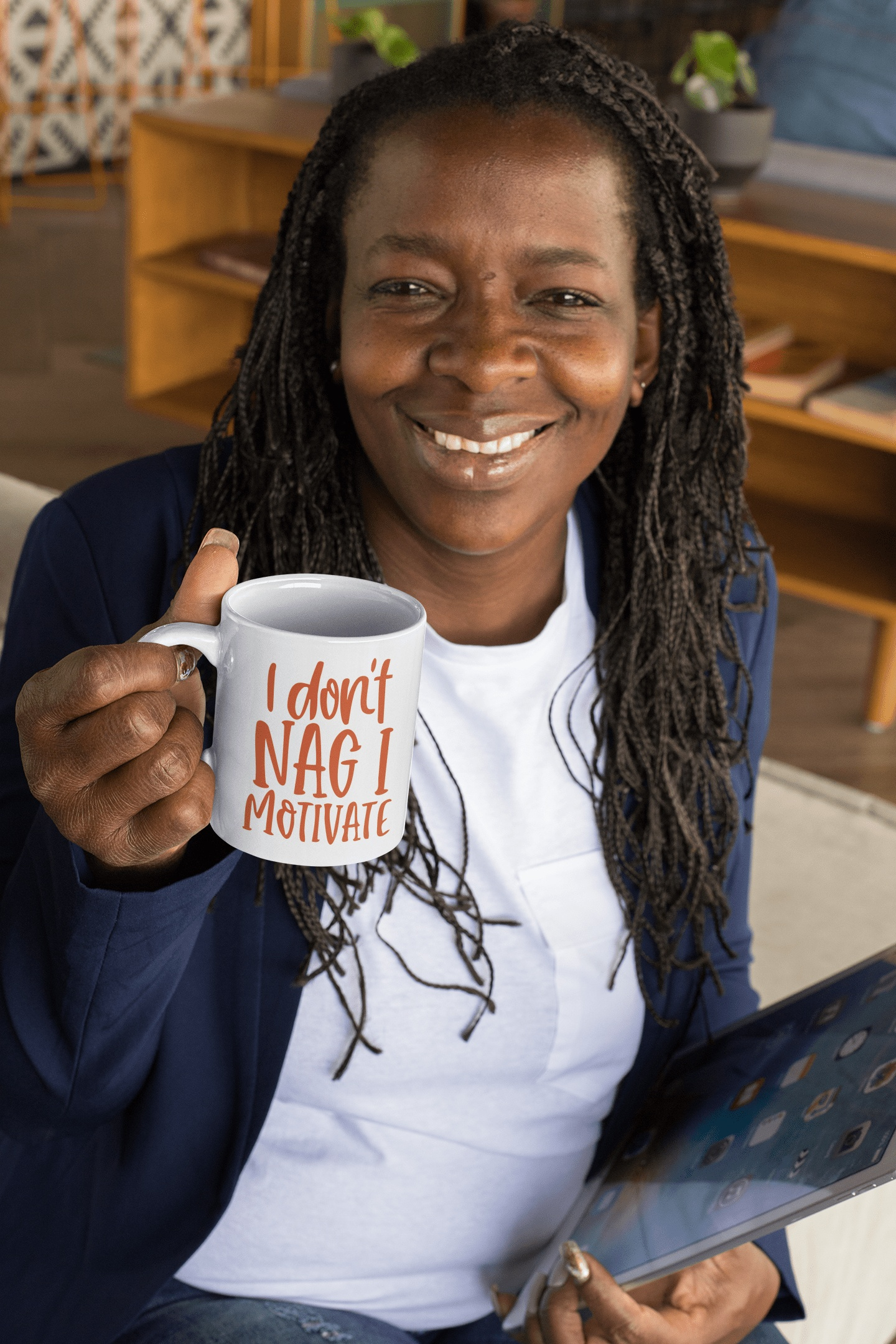 Smiling woman holding a 15 oz humorous ceramic mug with "I don't nag I motivate" text, promoting motivation and positivity