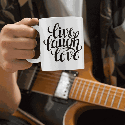 White ceramic coffee mug with "Live, Laugh, Love" design.