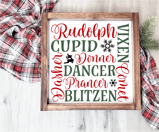 Handmade wood Christmas sign with reindeer names in red and green on a white background, framed in stained wood.