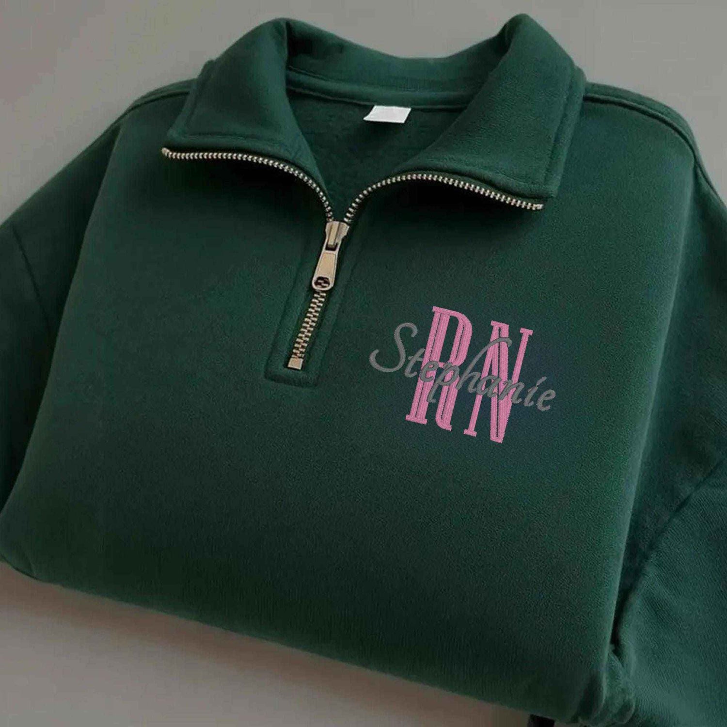 green quarter zip embroidered with nurse title -  RN and nurse name 
