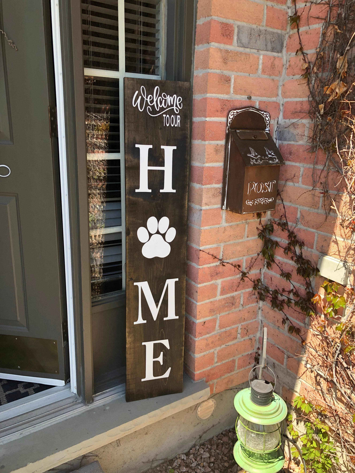 Handmade personalized porch sign for porch and patio decor with family name and paw print design
