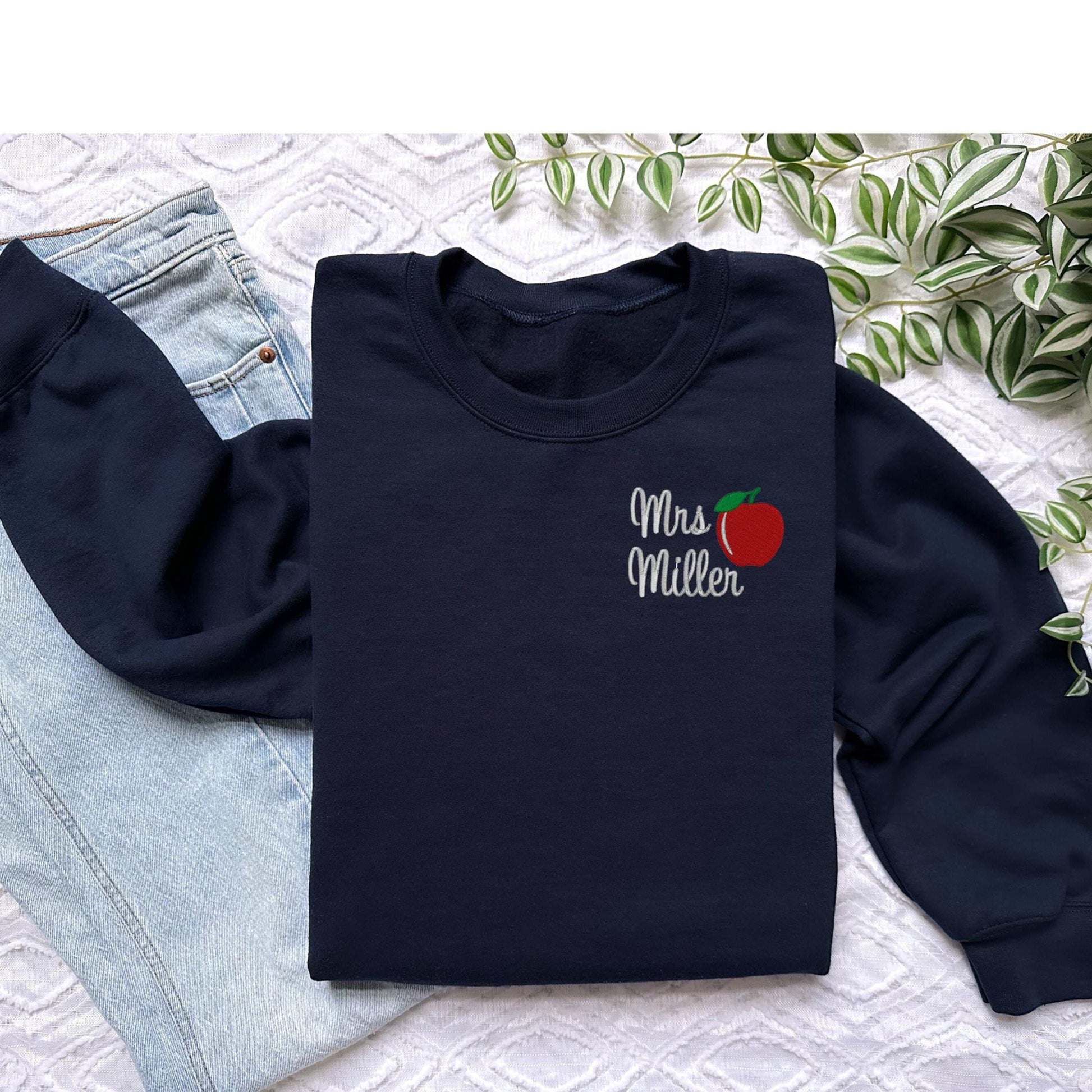 Personalized teacher sweatshirt with embroidered apple design and custom name