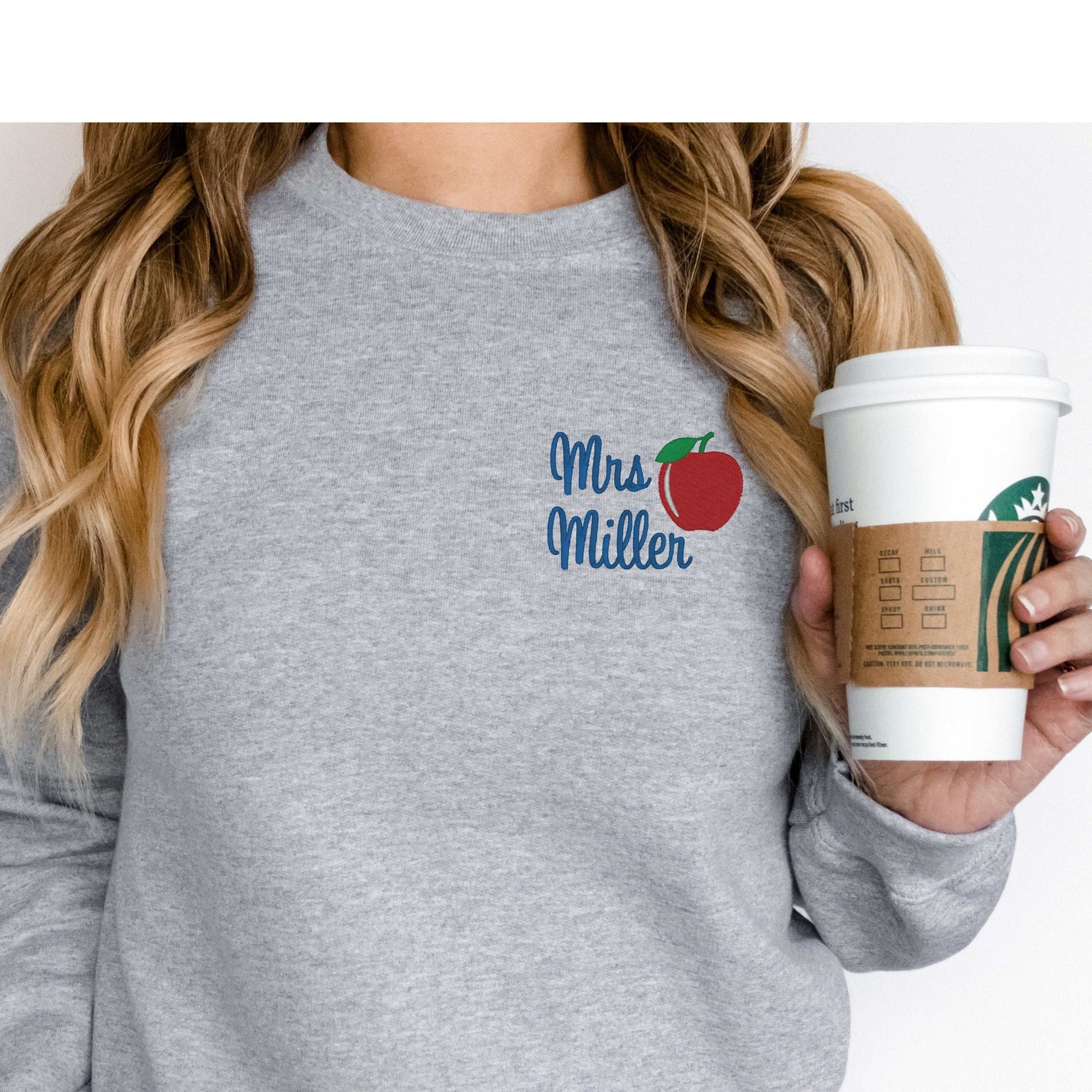 Personalized teacher sweatshirt with embroidered apple design and custom name embroidery