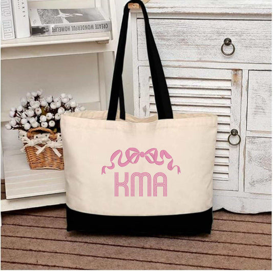 Navy canvas tote bag with monogrammed bow embroidery and cotton handles