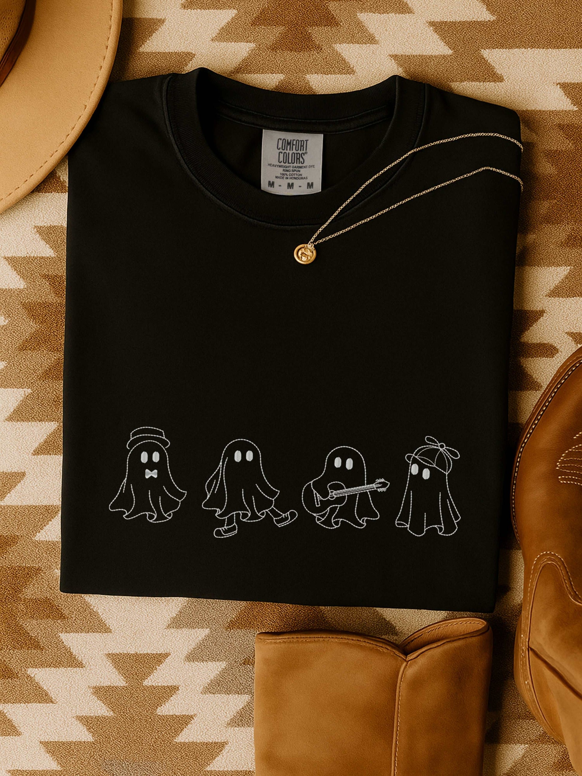Black t-shirt with embroidered playful ghost crew design, styled for Halloween and fall.