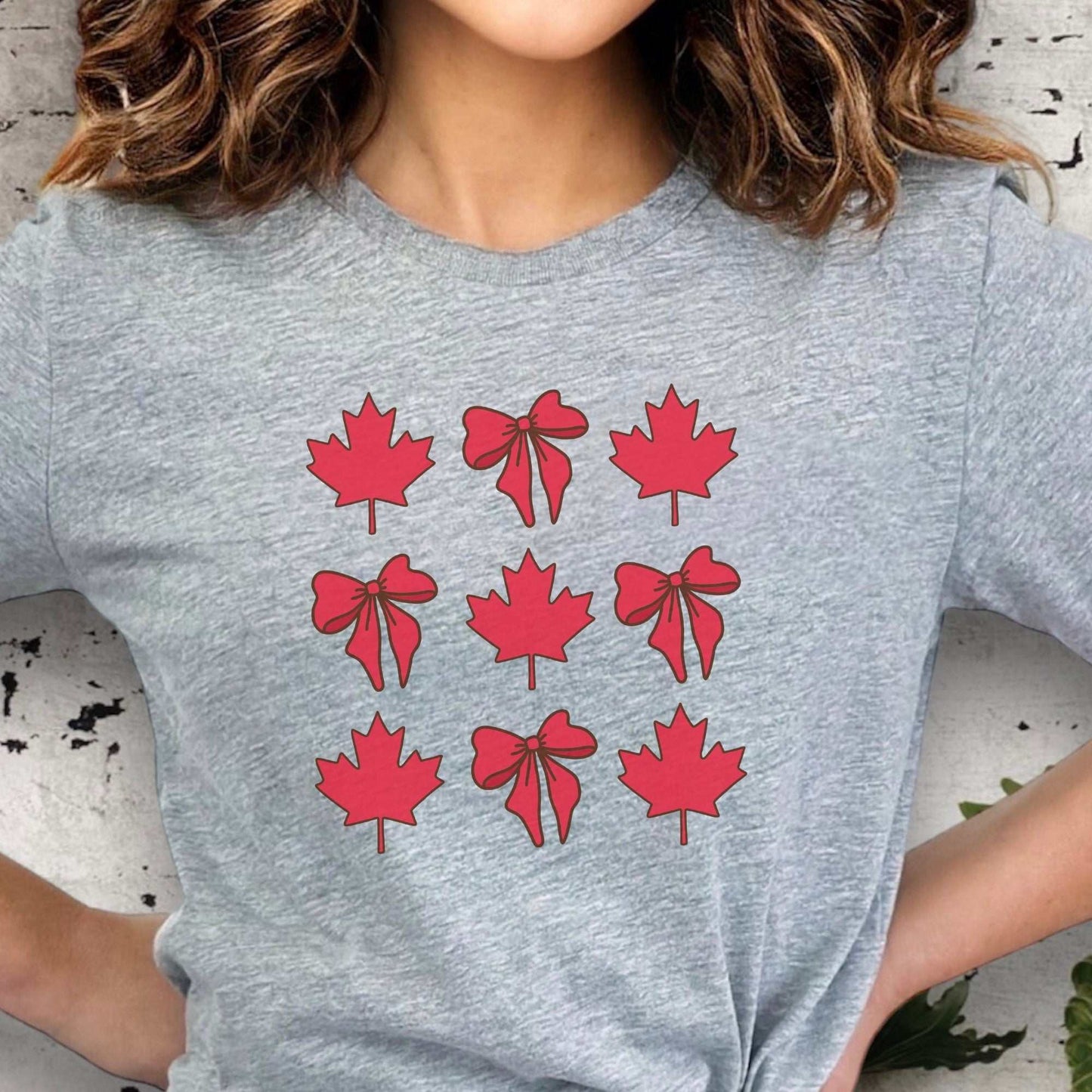 Unisex Canadian Maple Leaf & Ribbon T-Shirt celebrating Canada Day with vibrant symbols, ideal for casual and festive occasions.