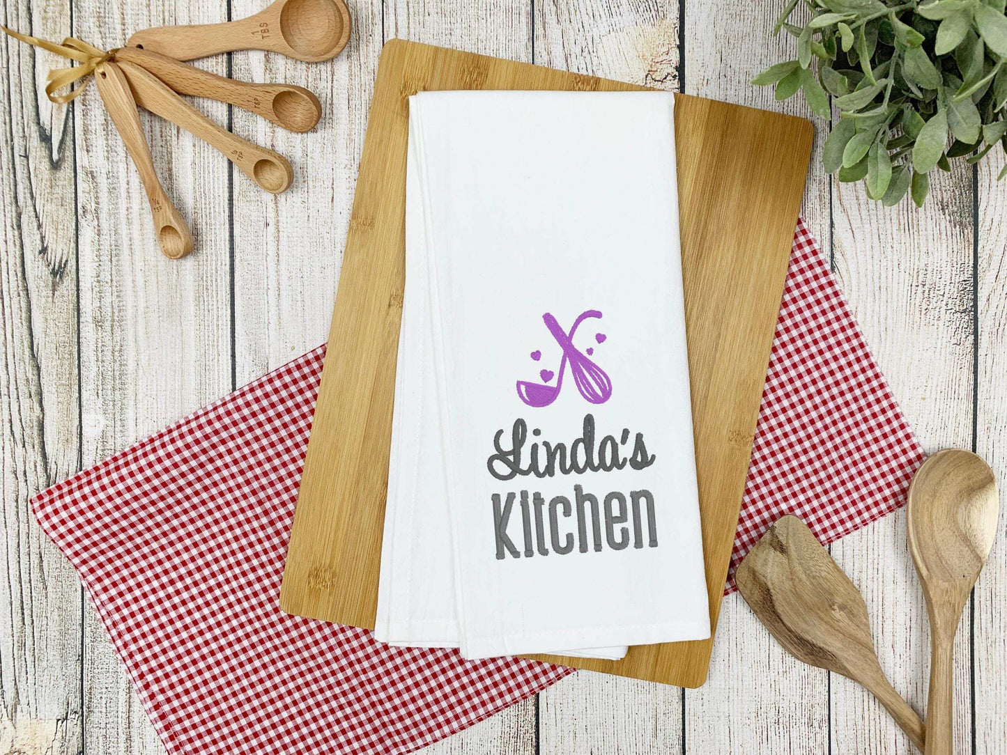 Personalized kitchen towel with embroidered whisk, spoon, hearts, and custom name in chosen thread color