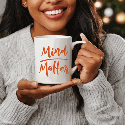 Woman holding "Mind over Matter" inspirational ceramic mug.