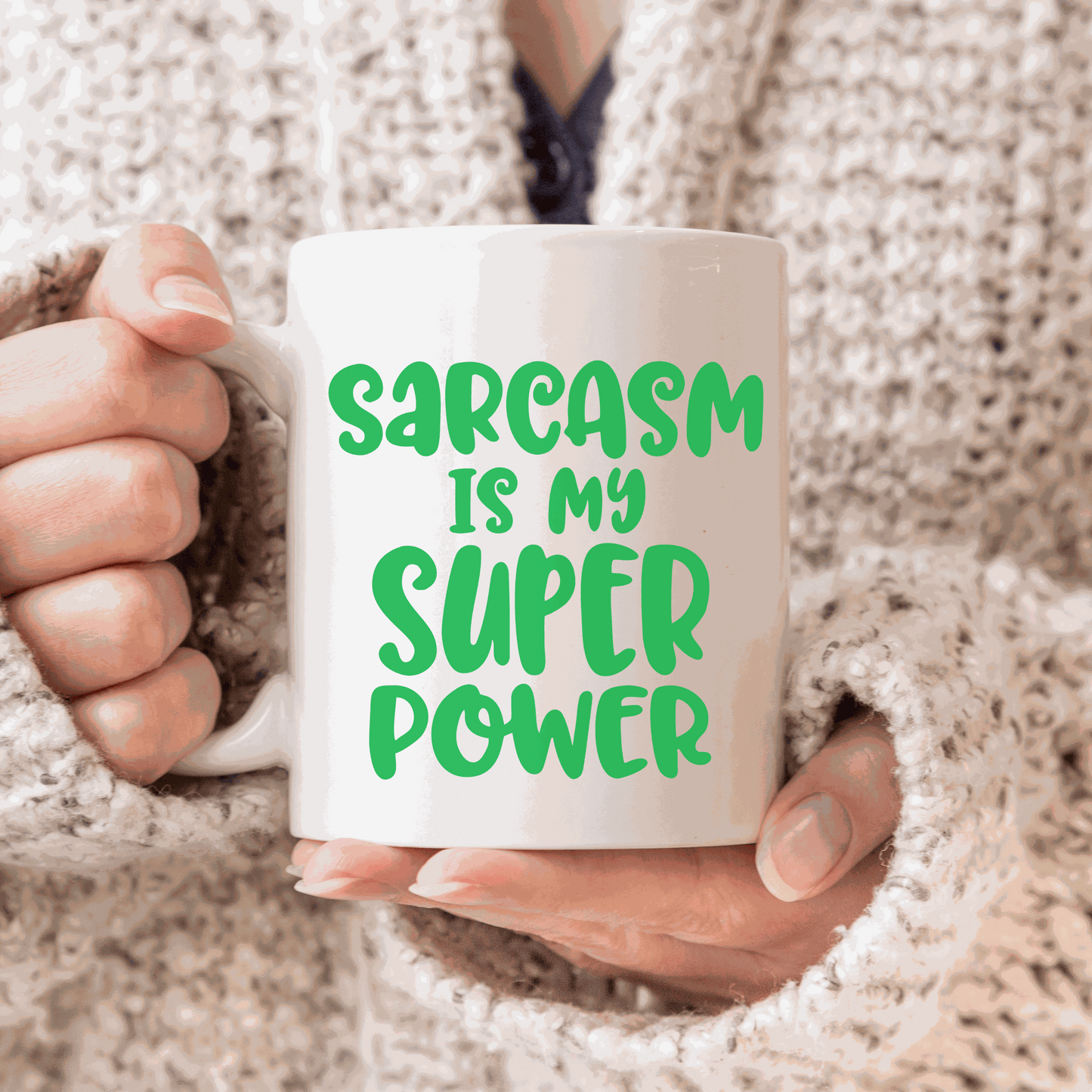 Sarcasm is my super power ceramic mug held by person in sweater, 11 oz white glossy humorous mug.