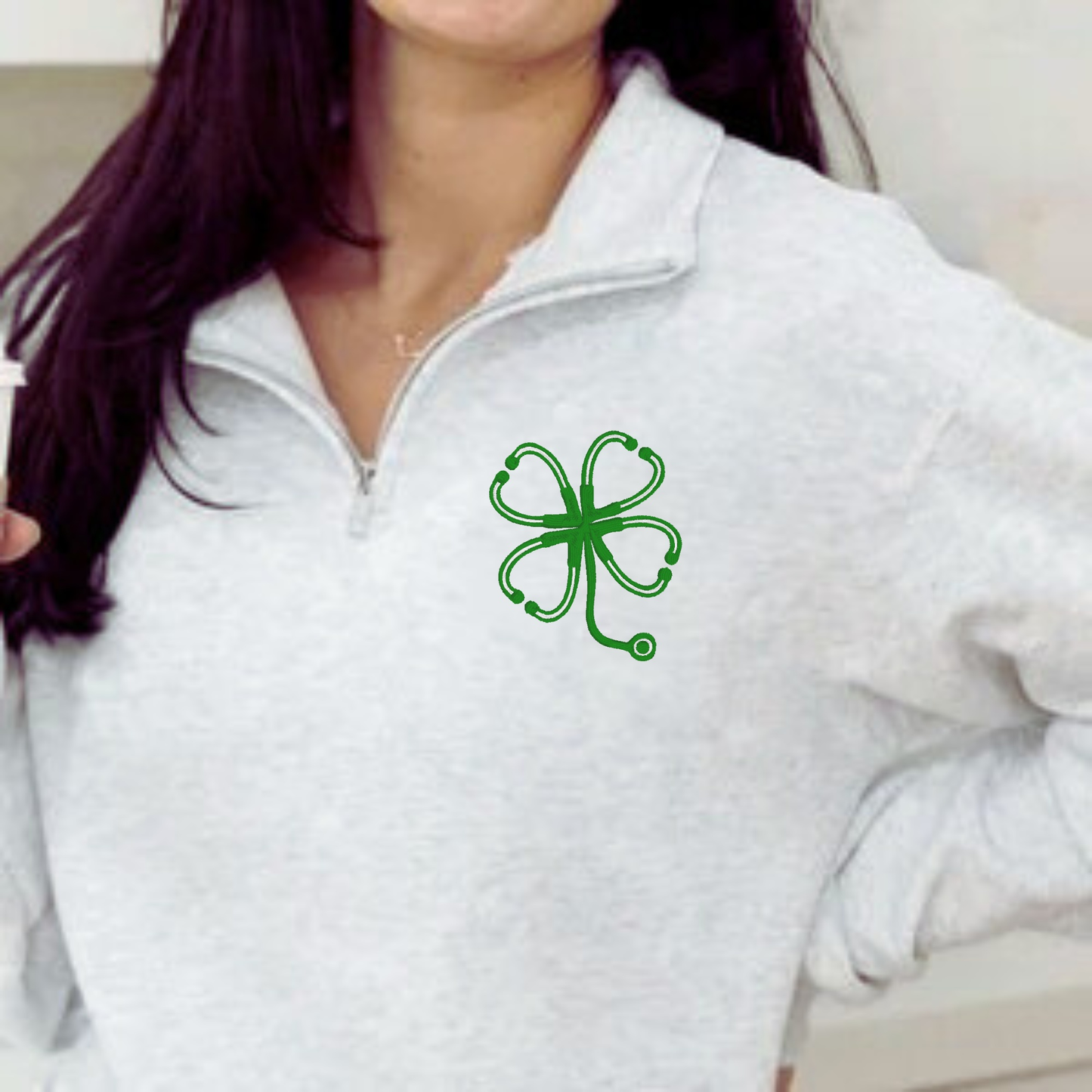 Shamrock embroidered nurse quarter zip sweater with clover stethoscope design for healthcare workers