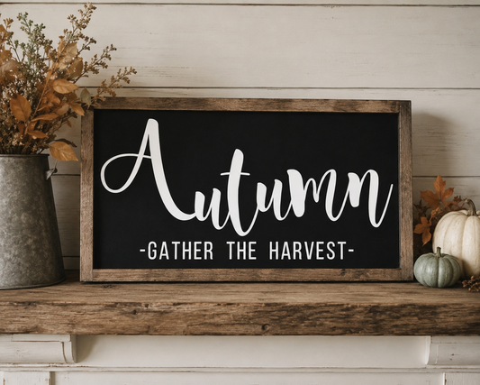 Autumn-themed sign with 'Gather the Harvest' on a wooden shelf with decorative elements.