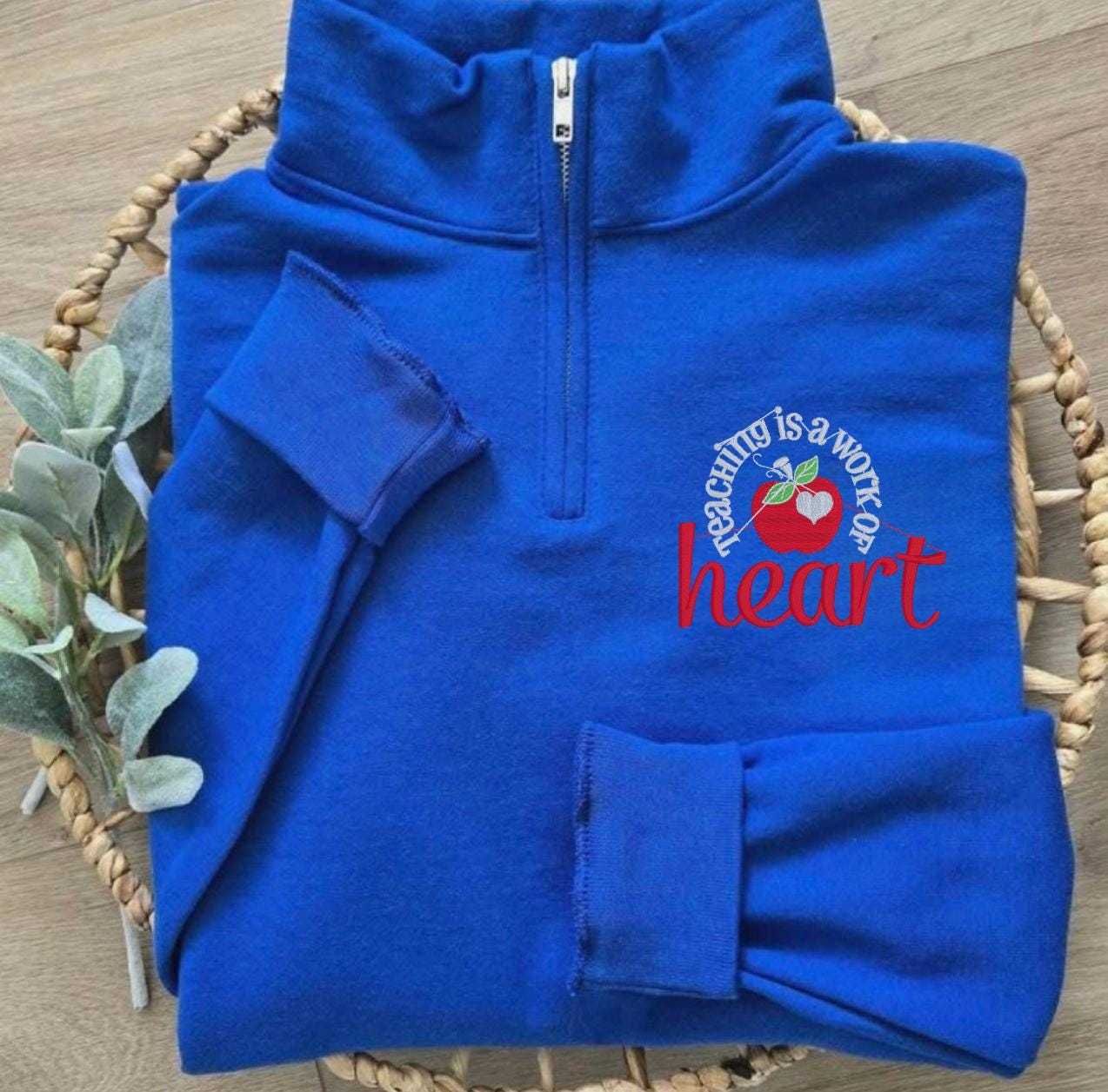 Teaching Is a Work of Heart embroidered quarter zip sweatshirt with red apple design for teacher appreciation gift