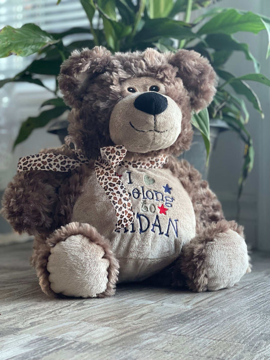 Personalized stuffed bear with embroidered details, ideal custom baby gift.