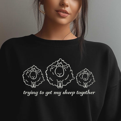 Embroidered black sweatshirt with "Trying to Get My Sheep Together" and cute sheep design.