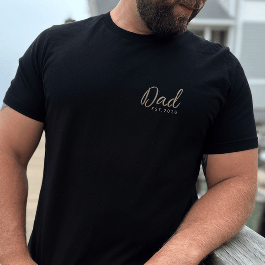 Man wearing a black t-shirt with 'Dad EST. 2026' text.