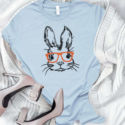 Adorable unisex Easter Bunny with glasses graphic tee in pastel blue, perfect for spring celebrations.