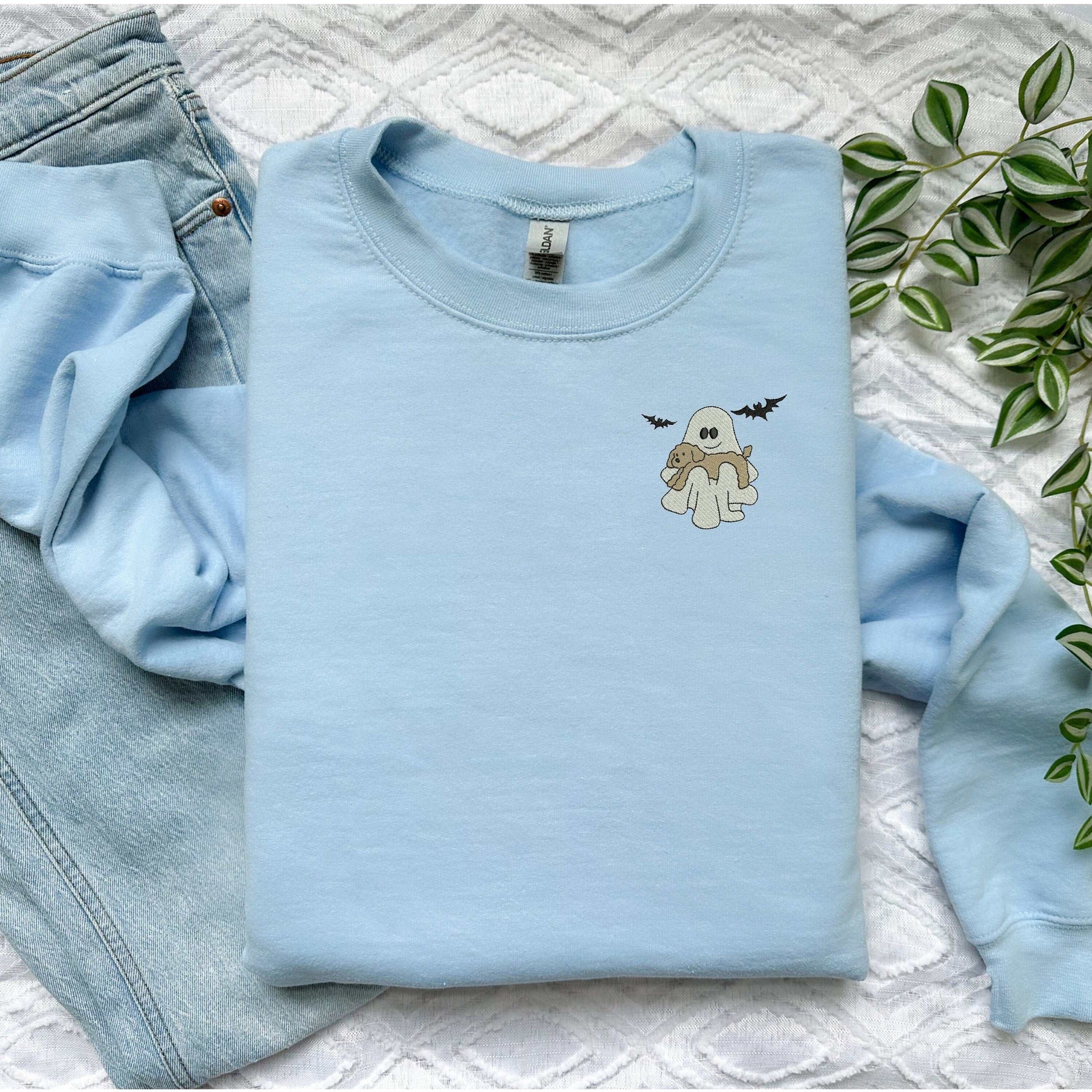 Halloween crewneck with embroidered ghost and dog design, light blue.