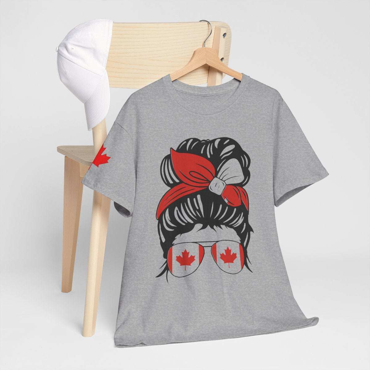 Canada-inspired unisex heavy cotton tee with bold graphic design featuring red bandana and maple leaf sunglasses, perfect for Canada Day and casual wear.