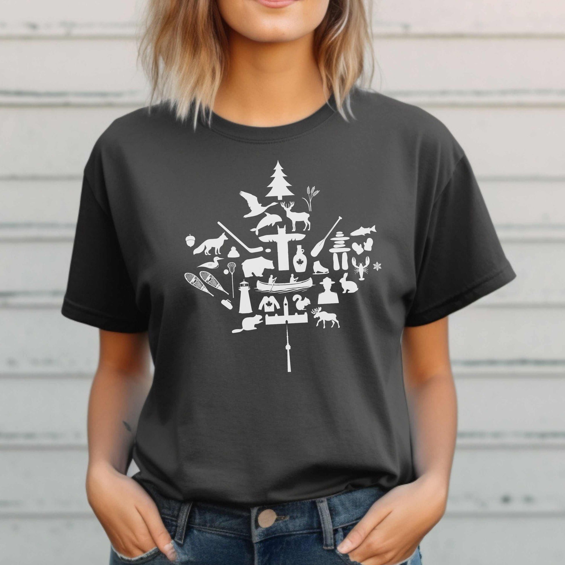 Unisex black t-shirt with white maple leaf design featuring iconic Canadian imagery like moose and canoes.