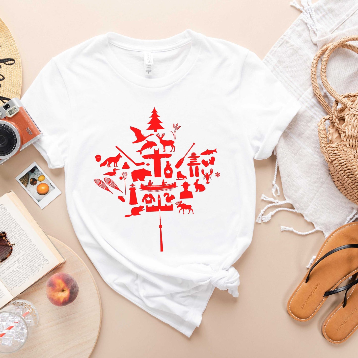 White Canada Icons Maple Leaf T-Shirt featuring a red maple leaf made of iconic Canadian imagery like moose
