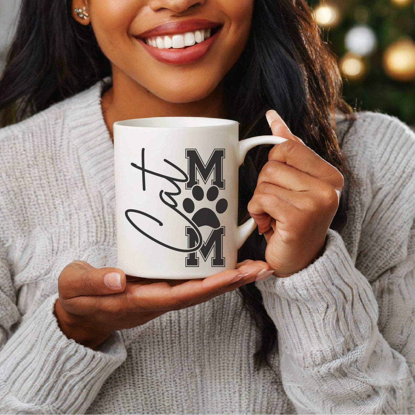 Cat Mom ceramic mug with varsity lettering and paw print design, ideal for coffee, tea, or cocoa.