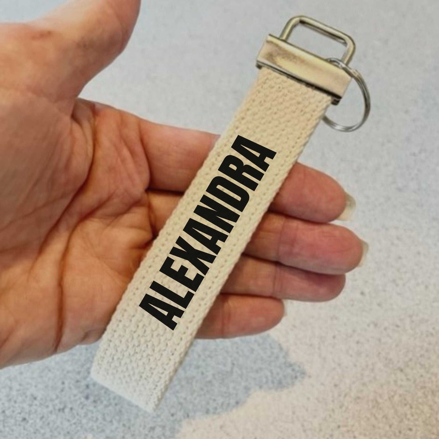 Beige cotton canvas keychain wristlet with metal hardware and customized name Alexandra