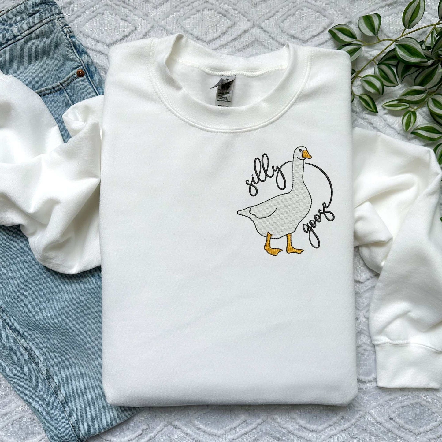 Pink sweatshirt with "Silly Goose" embroidery, featuring a playful goose design.