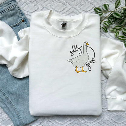 Pink sweatshirt with "Silly Goose" embroidery, featuring a playful goose design.