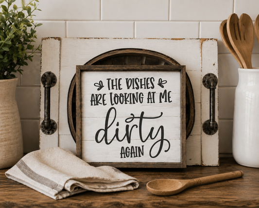 Decorative sign with humorous text in a kitchen setting with utensils and a plant.