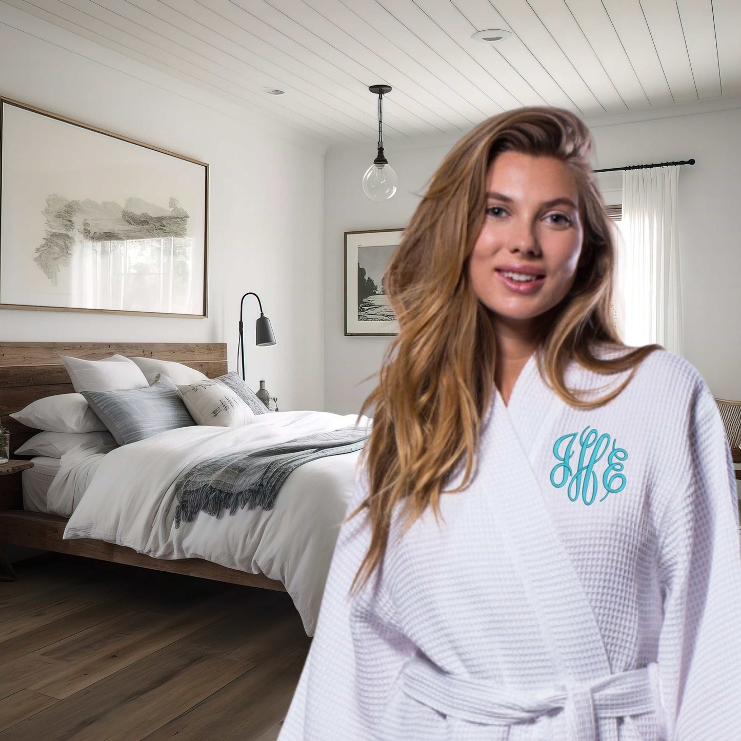 Woman in personalized white waffle spa robe with embroidered initials in cozy bedroom setting