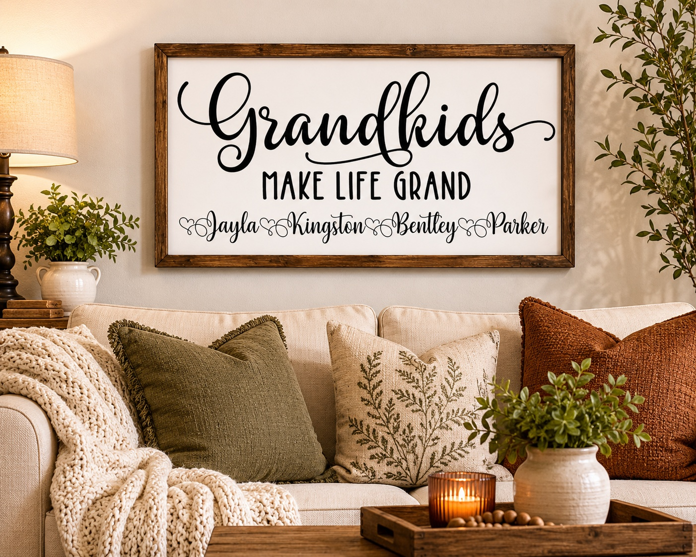 Decorative sign on a wall above a couch with pillows and a candle.