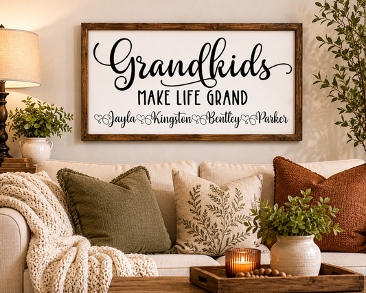 Decorative sign on a wall above a couch with pillows and a candle.