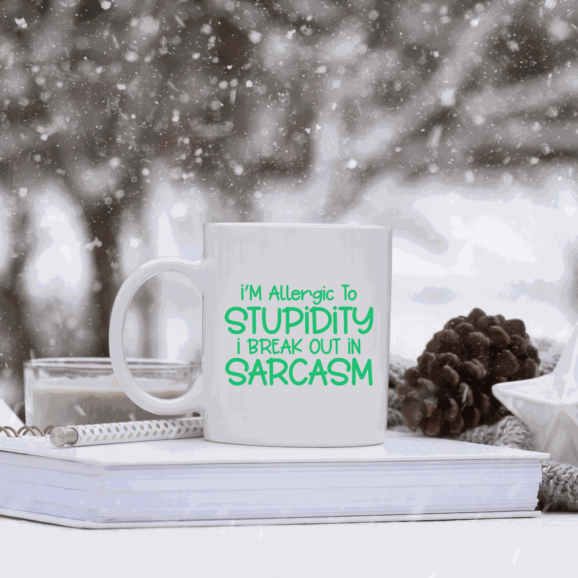 Ceramic coffee mug with "I'm Allergic to Stupidity I Break Out in Sarcasm" text in green. Perfect humorous gift.