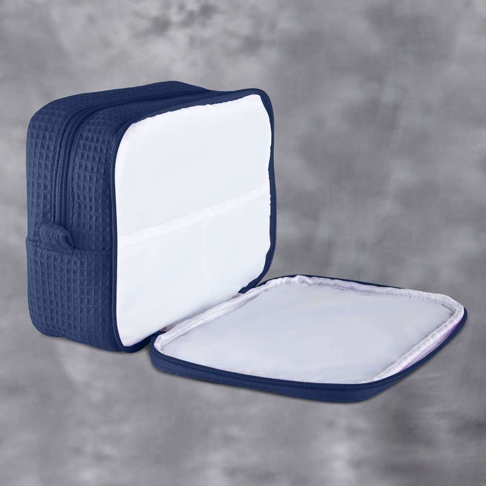 Monogrammed cosmetic bag with soft waffle texture and zipped compartments for makeup and accessories