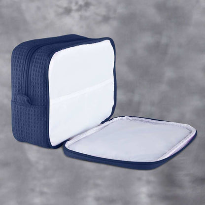 Monogrammed cosmetic bag with soft waffle texture and zipped compartments for makeup and accessories