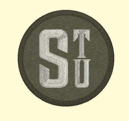 3-inch round custom name patch with initials "STU" embroidered on dark fabric.