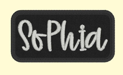 Custom embroidered name patch with "Sophia" in white text on a black background for jackets.
