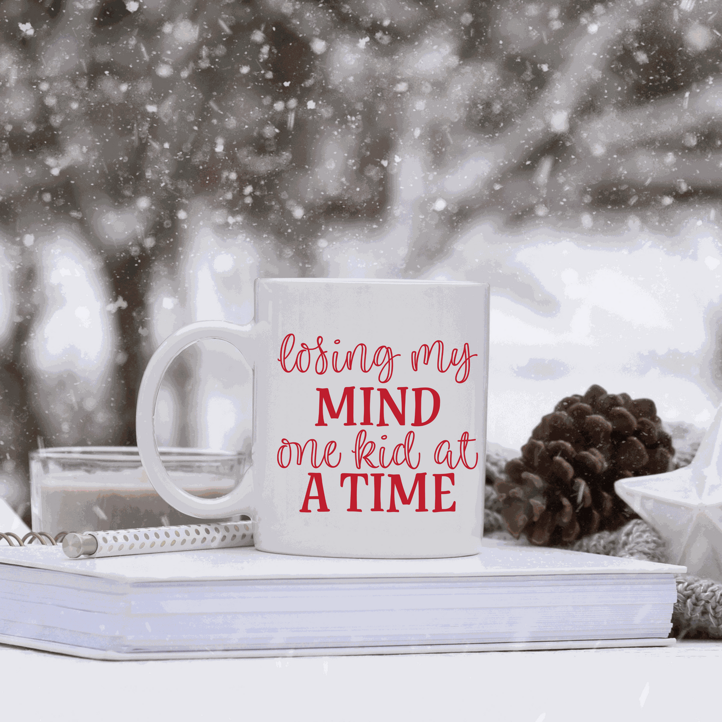 White ceramic mug with humorous "Losing my Mind one Kid at a Time" design.