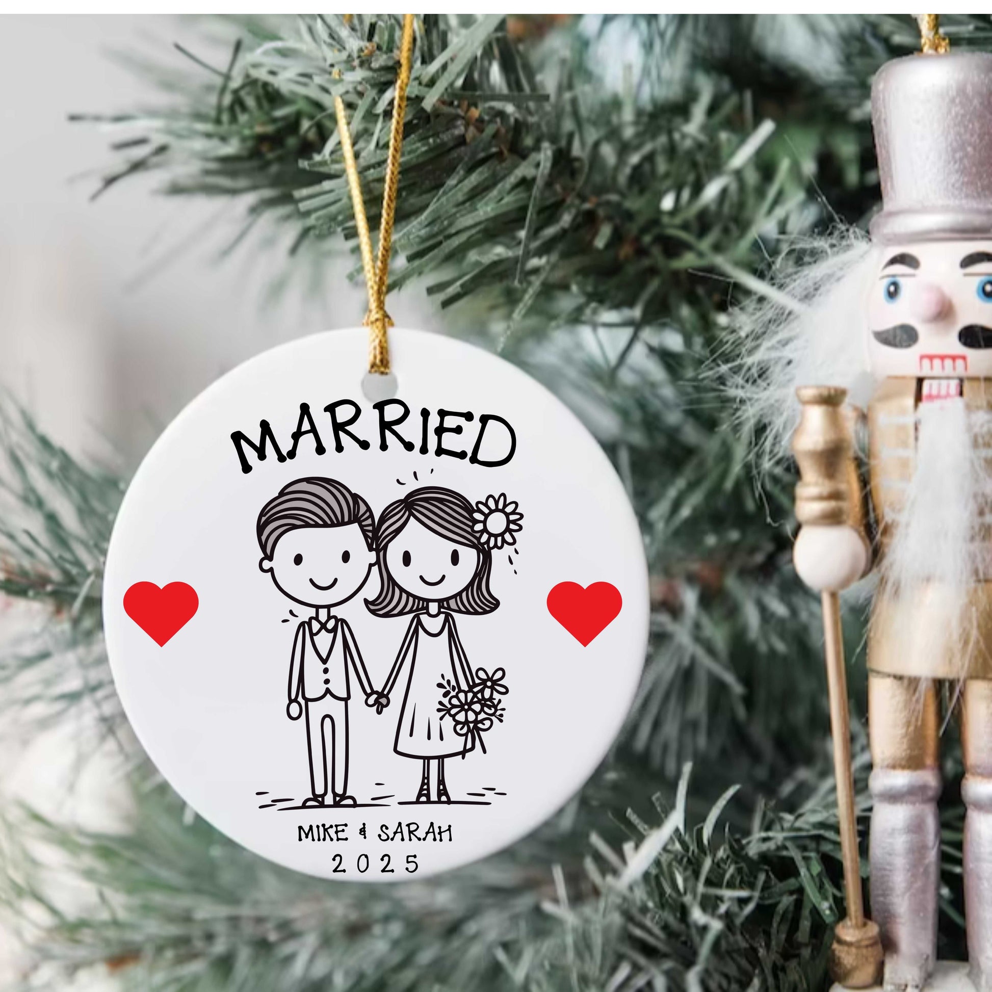 Personalized first Christmas married gift ornament with custom names and date, featuring a cute bride and groom illustration on a round porcelain bauble with gold hanging string.