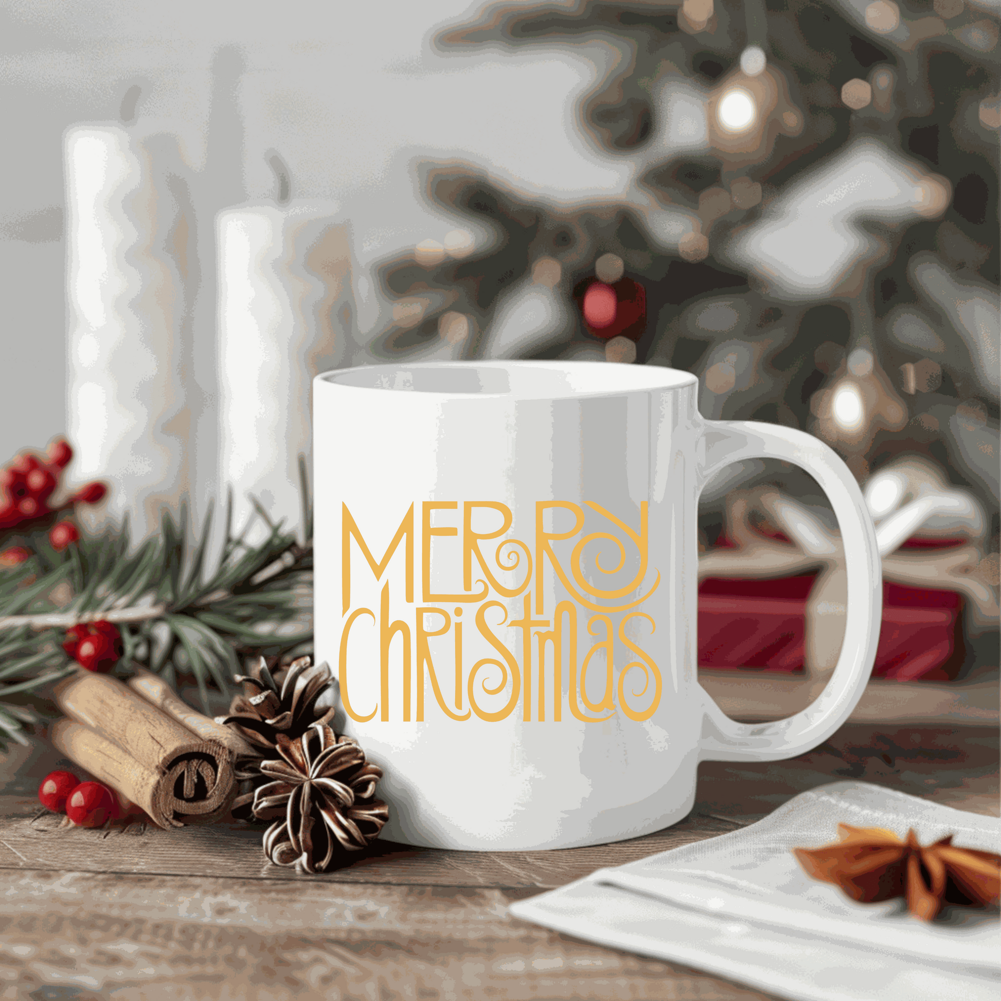 White ceramic mug with "Merry Christmas" design, surrounded by festive holiday decor.