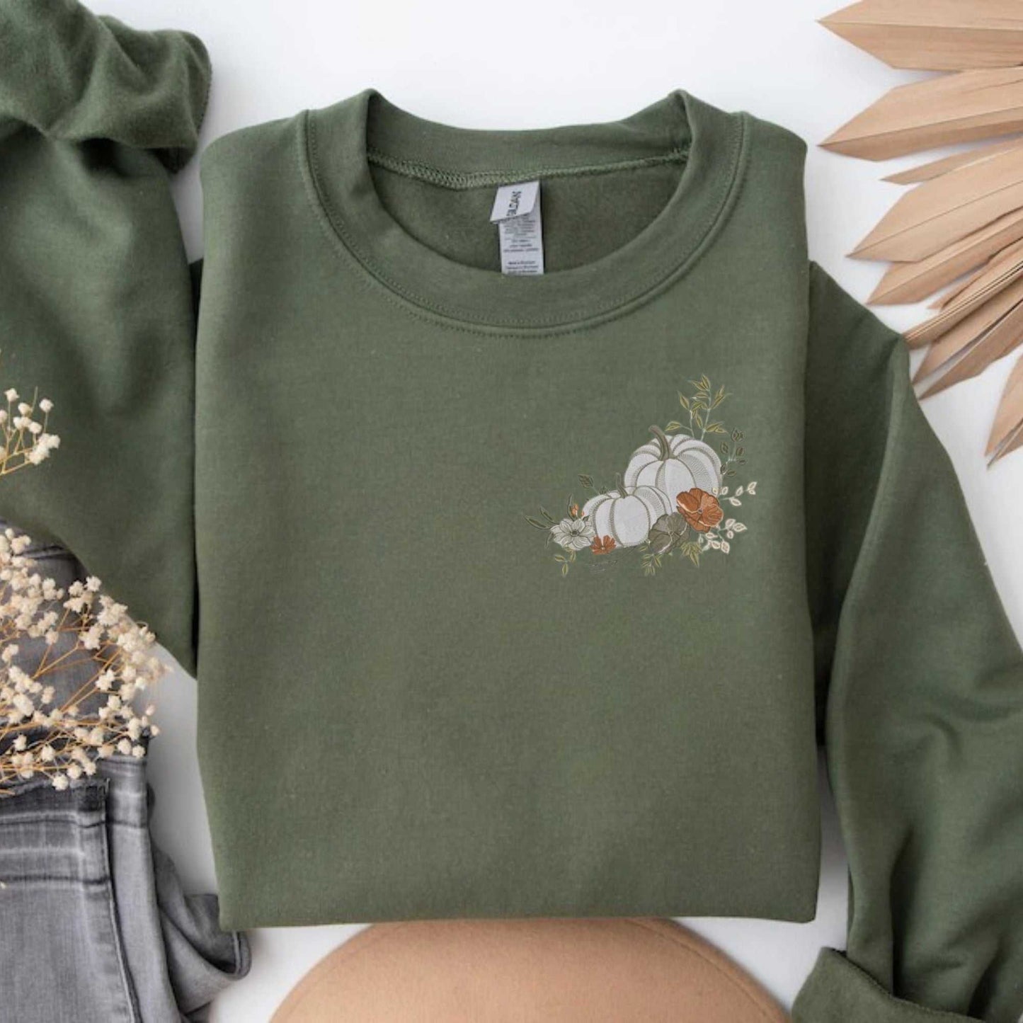 Olive green sweatshirt with white floral pumpkin embroidery, cozy cotton blend, perfect for fall season.