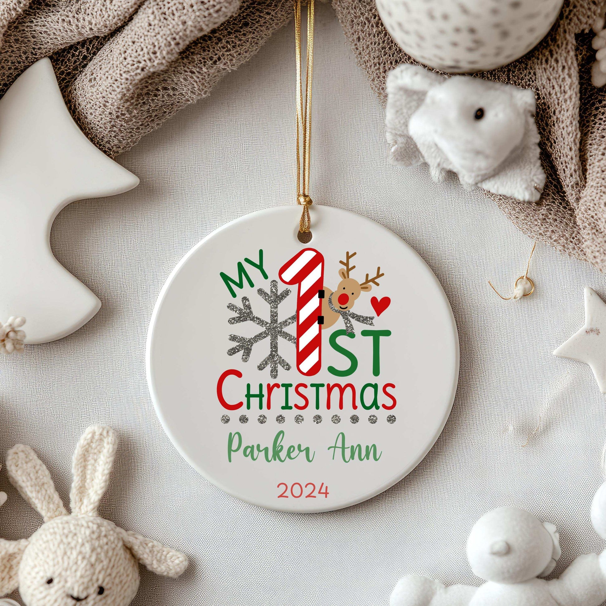 Personalized ceramic baby first Christmas ornament with name Parker Ann and year 2024, festive design including candy cane, snowflake, and reindeer on round white porcelain disk.