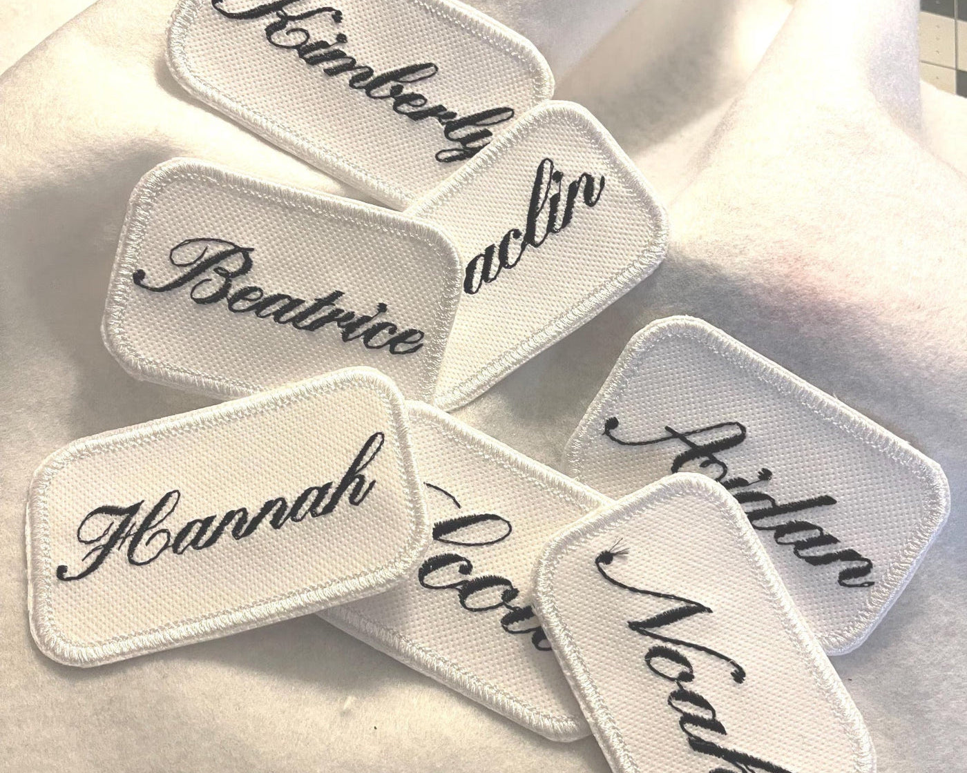 Set of embroidered name patches on a towel